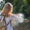 Woman,Tourist,Applying,Mosquito,Repellent,On,Hand,During,Hike,In